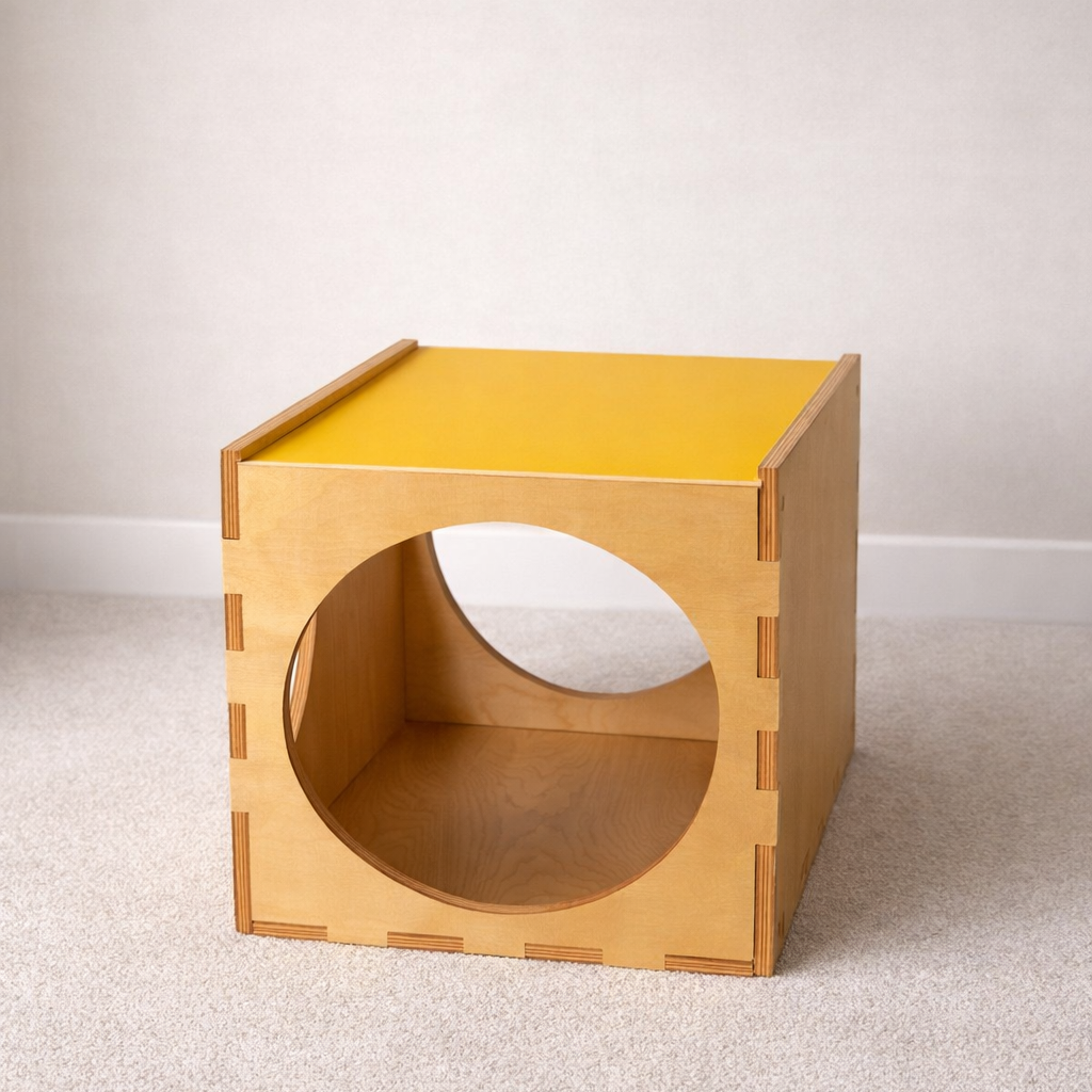 Wooden cube with a circular hole on a light gray background
