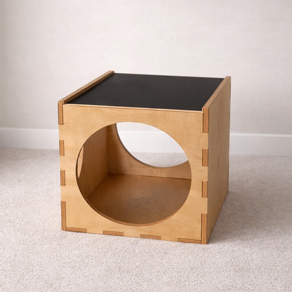 Wooden side table with a circular cutout on a plain background