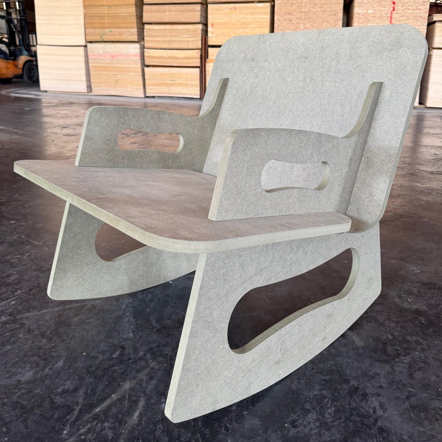 Modern chair with concrete base and wooden seat in a warehouse setting